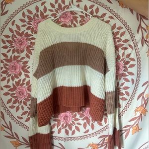 A size large sweater, cropped. And had a beige, white, and pink stripe.